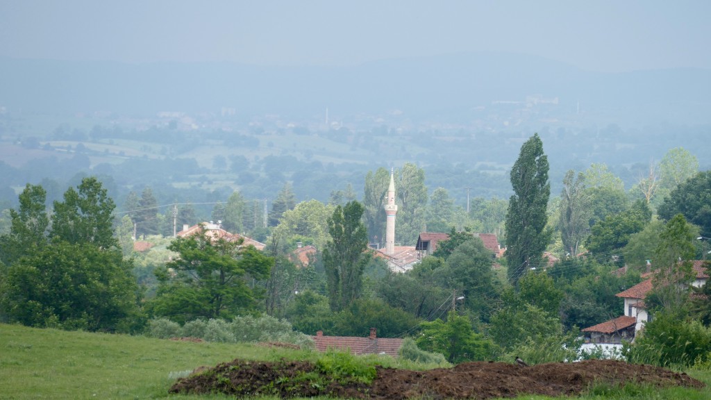 a little sunny village surrounded by thunderstorms.