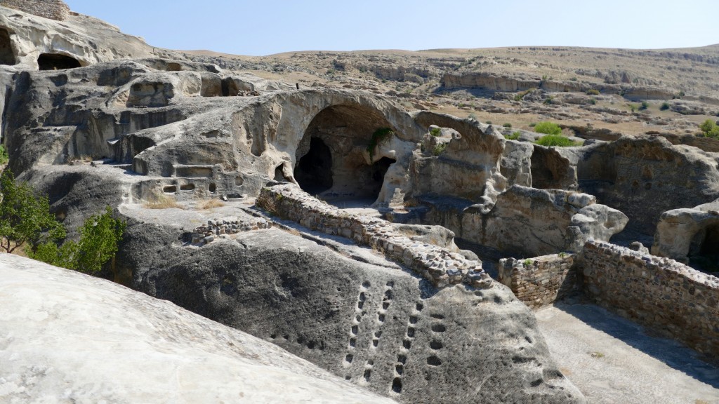 Uplistsikhe Uplistikhe is a rock-hewn city, located just 10 km east of Gori, on the left bank of the river Mtkvari. One of the oldest settlements in the Caucasus region, Uplistikhe is first mentioned within the pages of history in the VII century. Uplistiskhe and its surrounding archeological and architectural monuments belong to a distinct group, the oldest of which dates back to the early Bronze Age, and are considered to be relics of the Kura-Araxes culture.