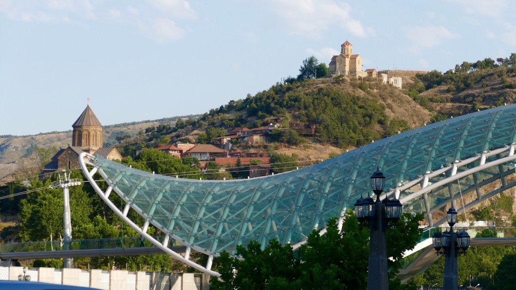 The Bridge of Peace and on the back Metekhi Church and on the top the Trinity Cathedral